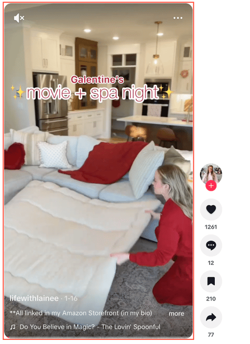 Woman setting up a cozy living room for a Galentine’s Day movie and spa night, reflecting social trends and consumer insights.